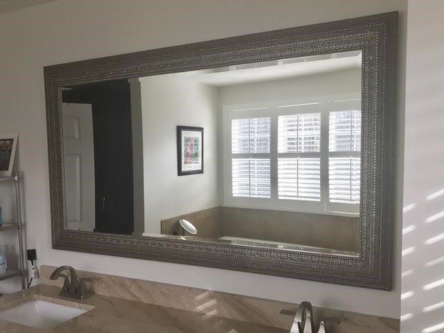 Uttermost framed beveled mirror on vanity